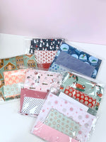 Christmas pillowcase fabric kits in festive prints: snowmen, snowflakes, gingerbread, plaid, and holiday scenes.