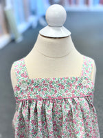 Floral dress on a mannequin with a blurred background