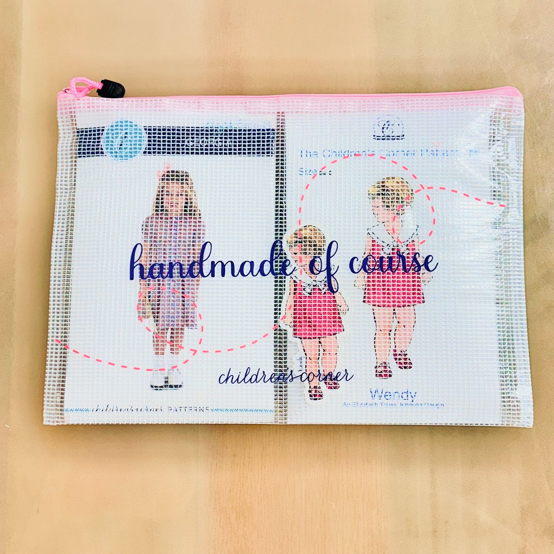Clear mesh zip pouch with pink zipper printed with handmade of course childrens corner