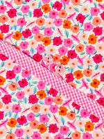 Floral print fabric with pink gingham collar and pink flower buttons