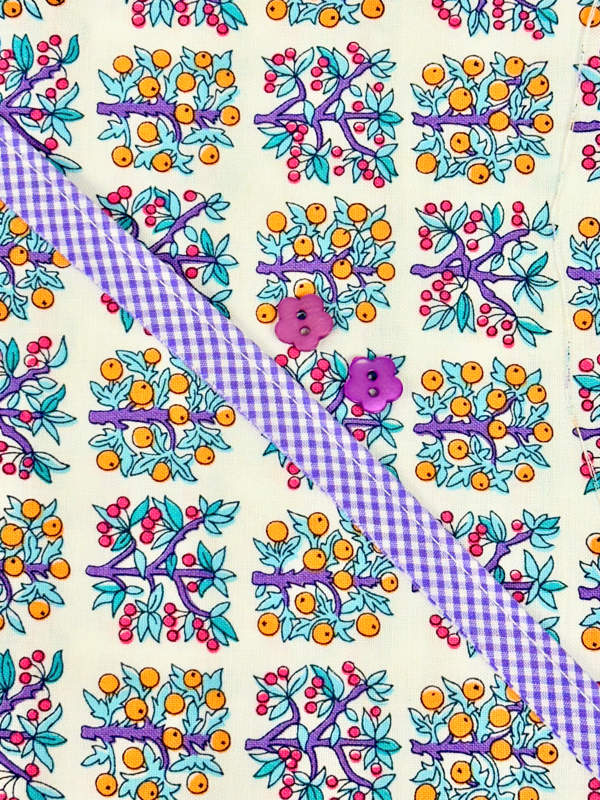 Floral fruit print fabric with purple gingham ribbon and two purple flower buttons