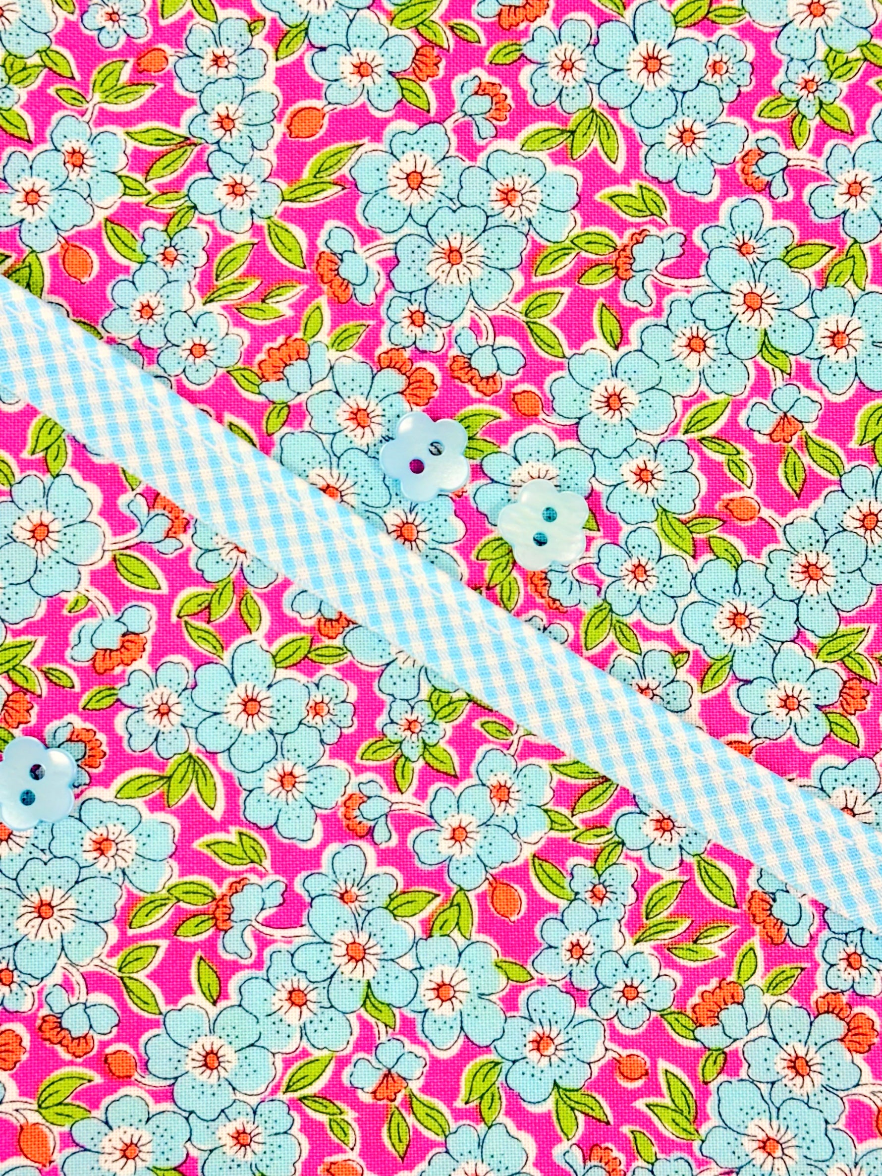 Louise Dress Kit with pink floral fabric, blue gingham trim, and light blue buttons
