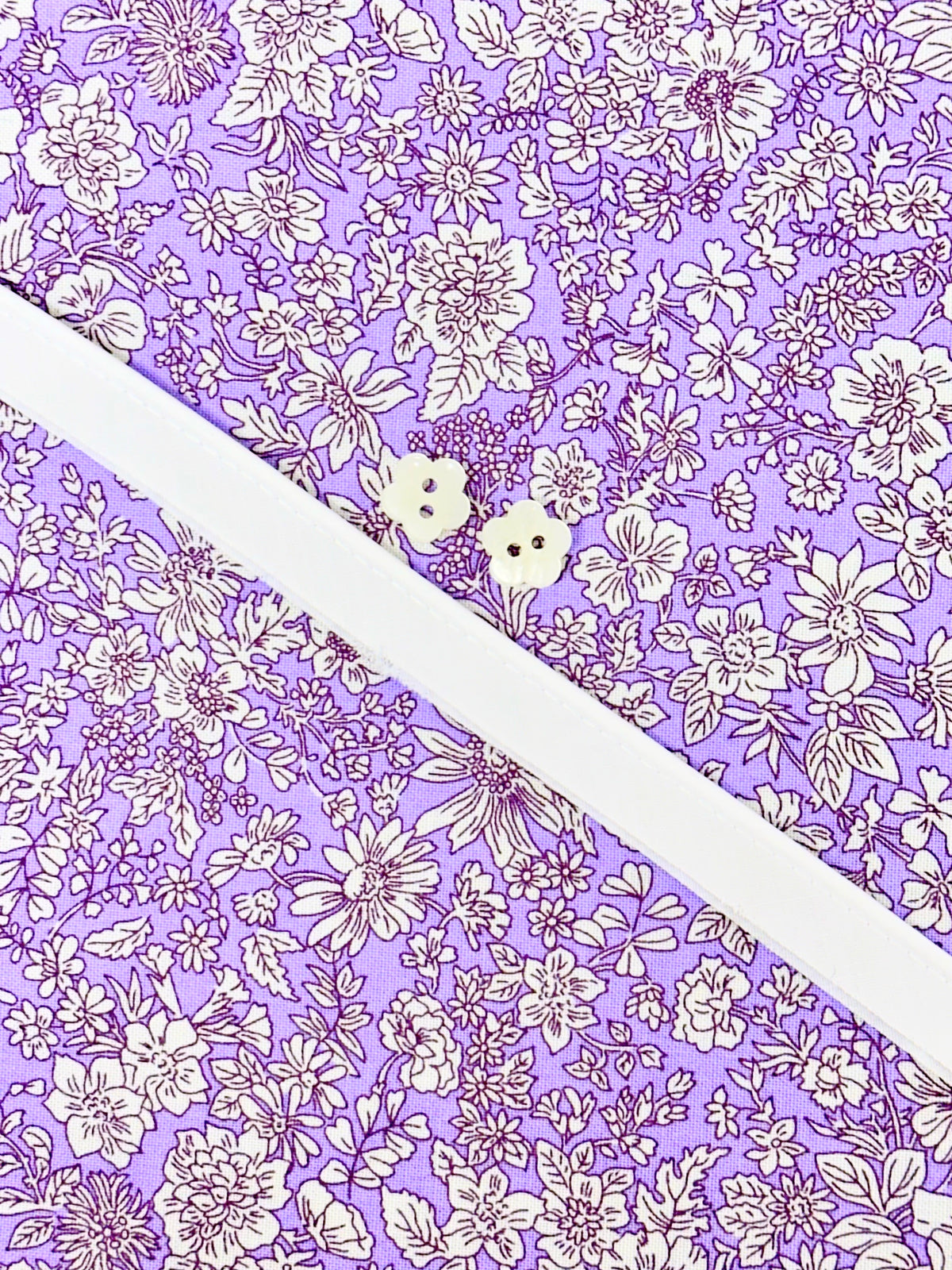 Purple floral cotton fabric with white buttons and white elastic for Louise Dress Kit