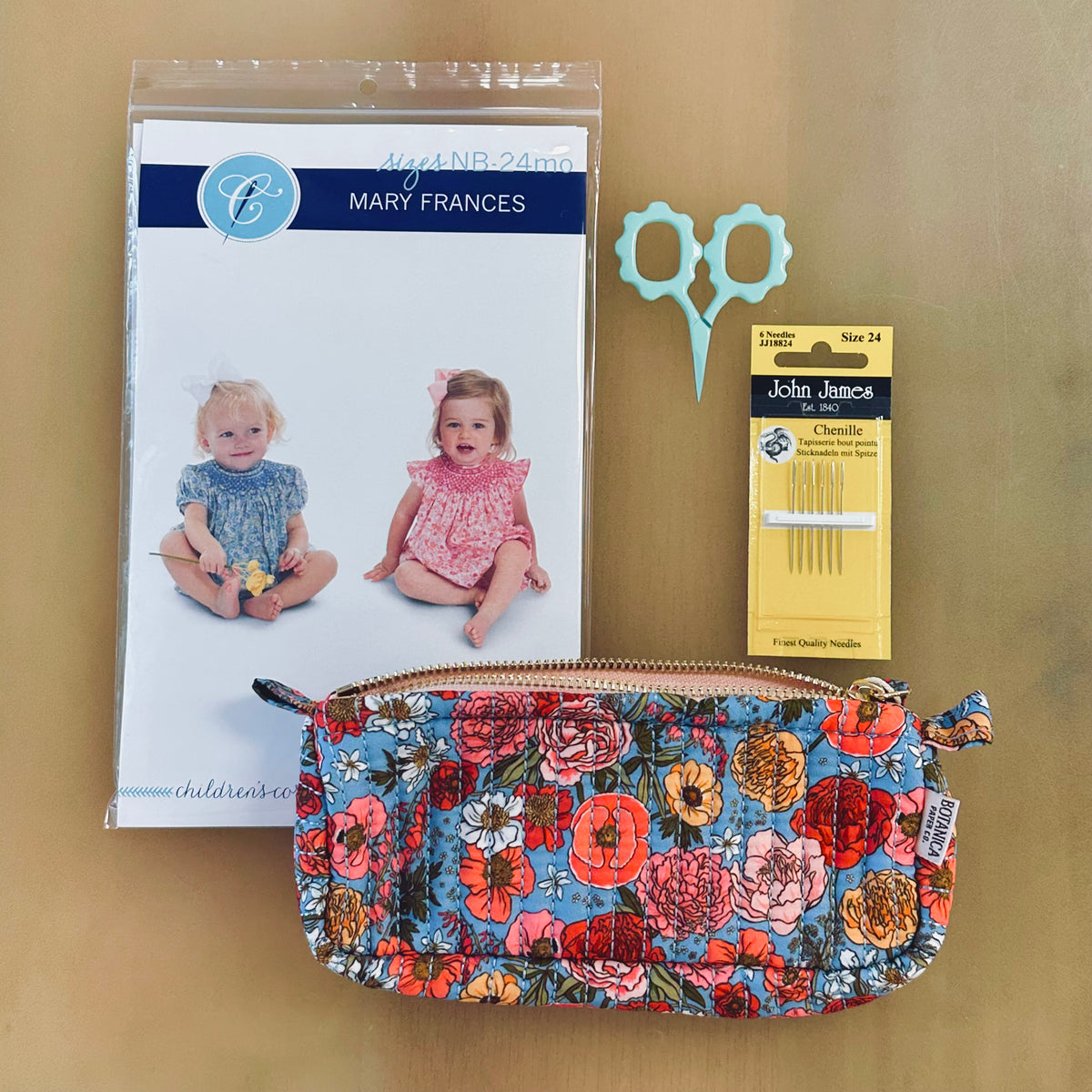 Mary Frances baby sewing pattern bundle with floral pouch, scissors, and needles