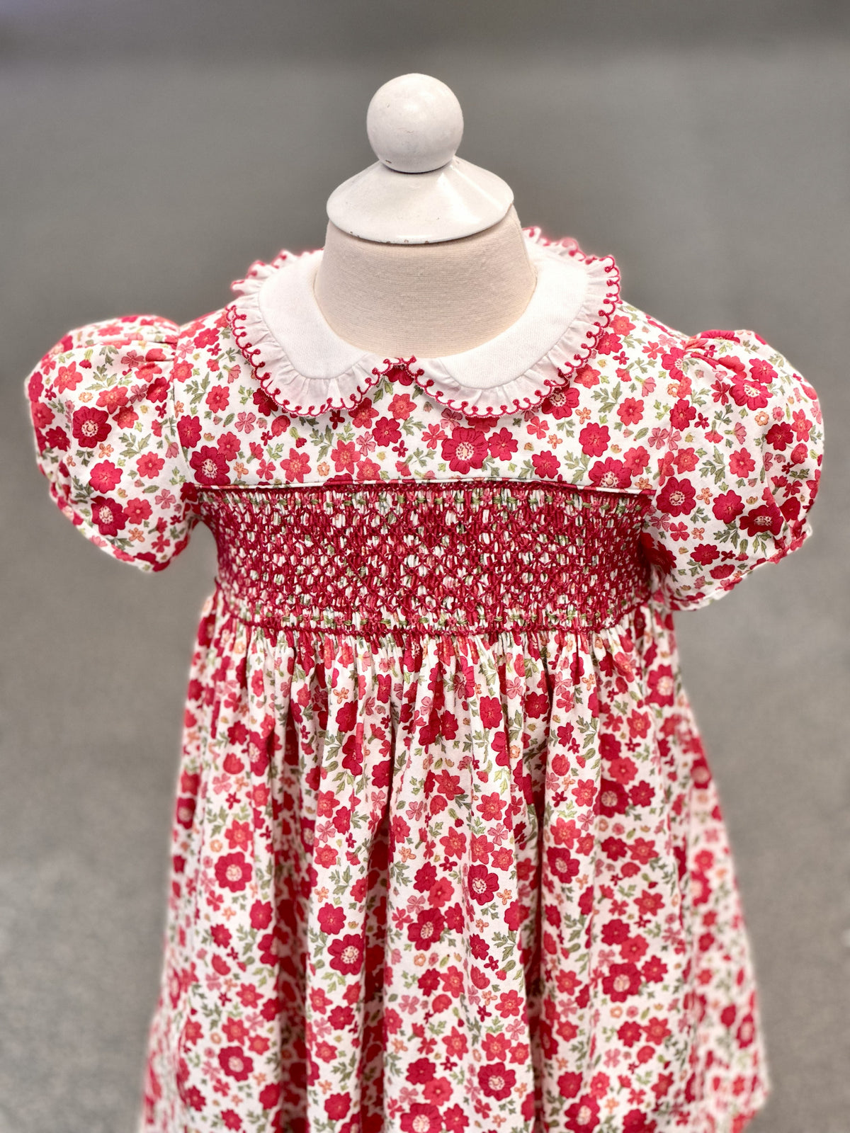 Red floral smocked toddler dress with white Peter Pan collar and puff sleeves