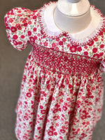 Red floral smocked girls dress with white Peter Pan collar and puff sleeves