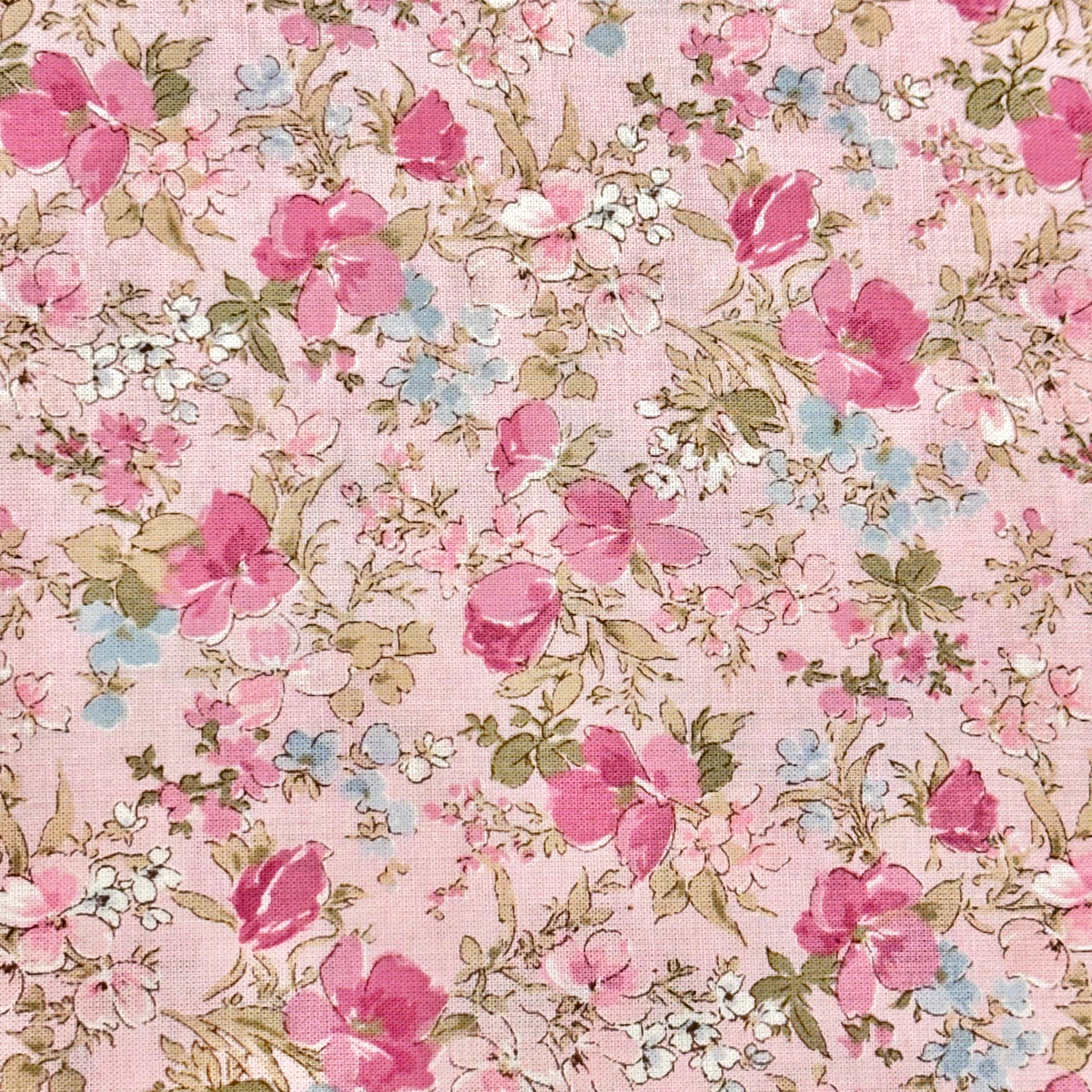 Pink cotton lawn fabric with scattered pink roses, white blooms, and sage green leaves