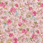 Pink cotton lawn fabric with scattered pink roses, white blooms, and sage green leaves