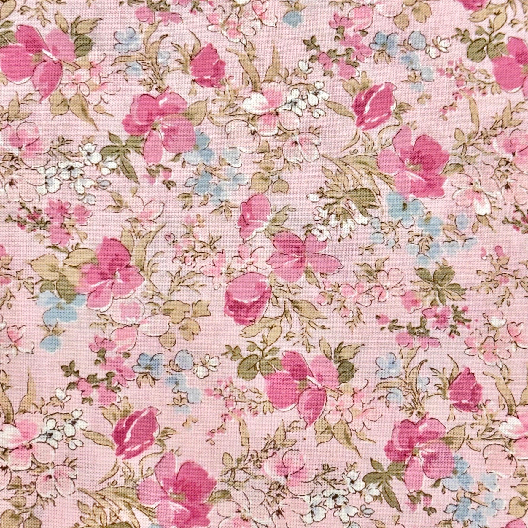 Pink cotton lawn fabric with scattered pink roses, white blooms, and sage green leaves