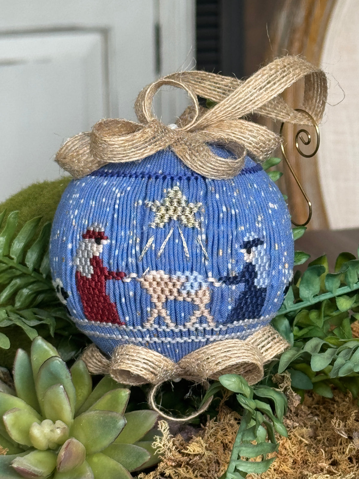 Blue smocked Christmas ornament with nativity scene and burlap ribbon bow