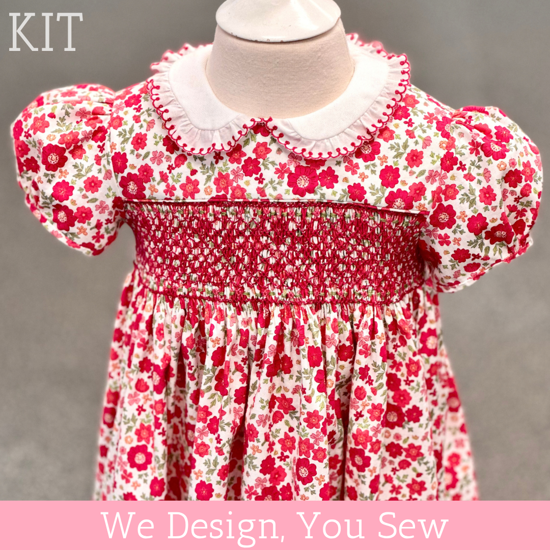 Red floral smocked baby dress kit with white Peter Pan collar and puff sleeves