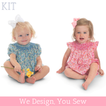 Two toddler girls wearing smocked floral bubble rompers in blue and pink prints