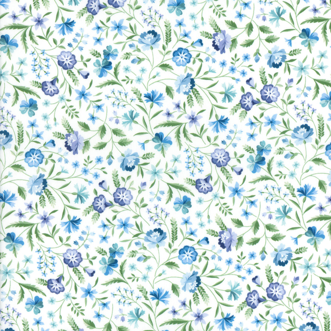 White cotton fabric with blue floral and green leaf allover print pattern