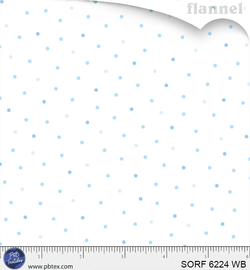 White flannel fabric with scattered blue polka dots in varied shades and sizes