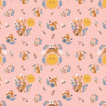 Pink fabric with golden suns, brown bunnies, blue florals, and bees in a folk art pattern.