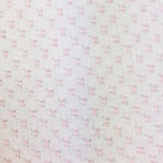 White sheer fabric with small scattered pink dot clusters in a dotted Swiss pattern