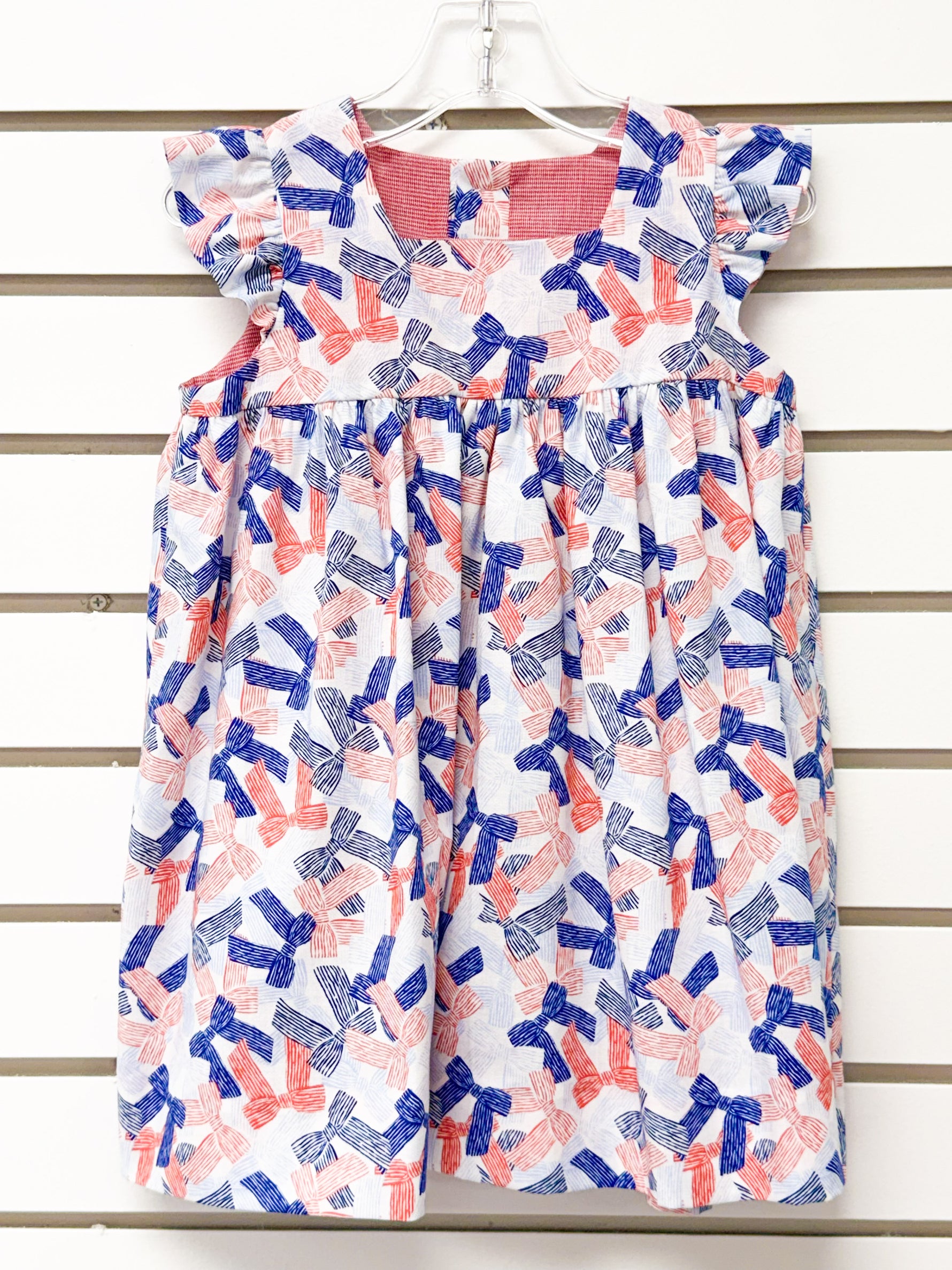 Girl's white dress with red and blue bow print, flutter sleeves, size 24mo