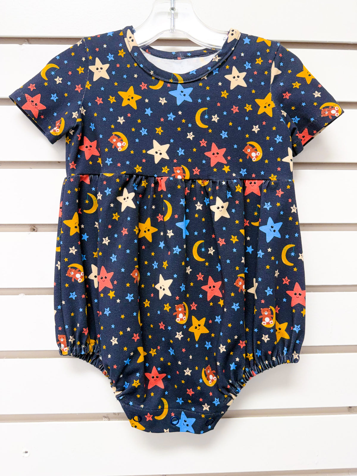 Navy baby romper with colorful stars and moons pattern, short sleeves, size 12mo