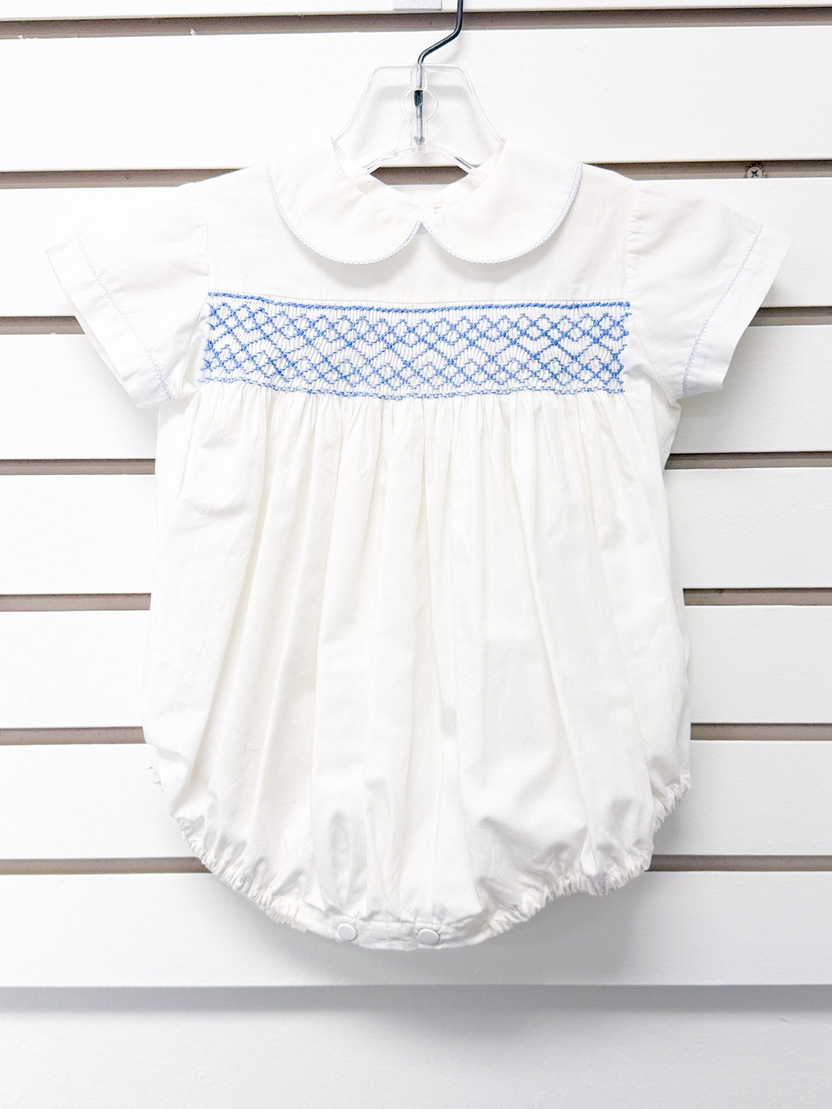 White smocked baby bubble romper with blue embroidery and peter pan collar