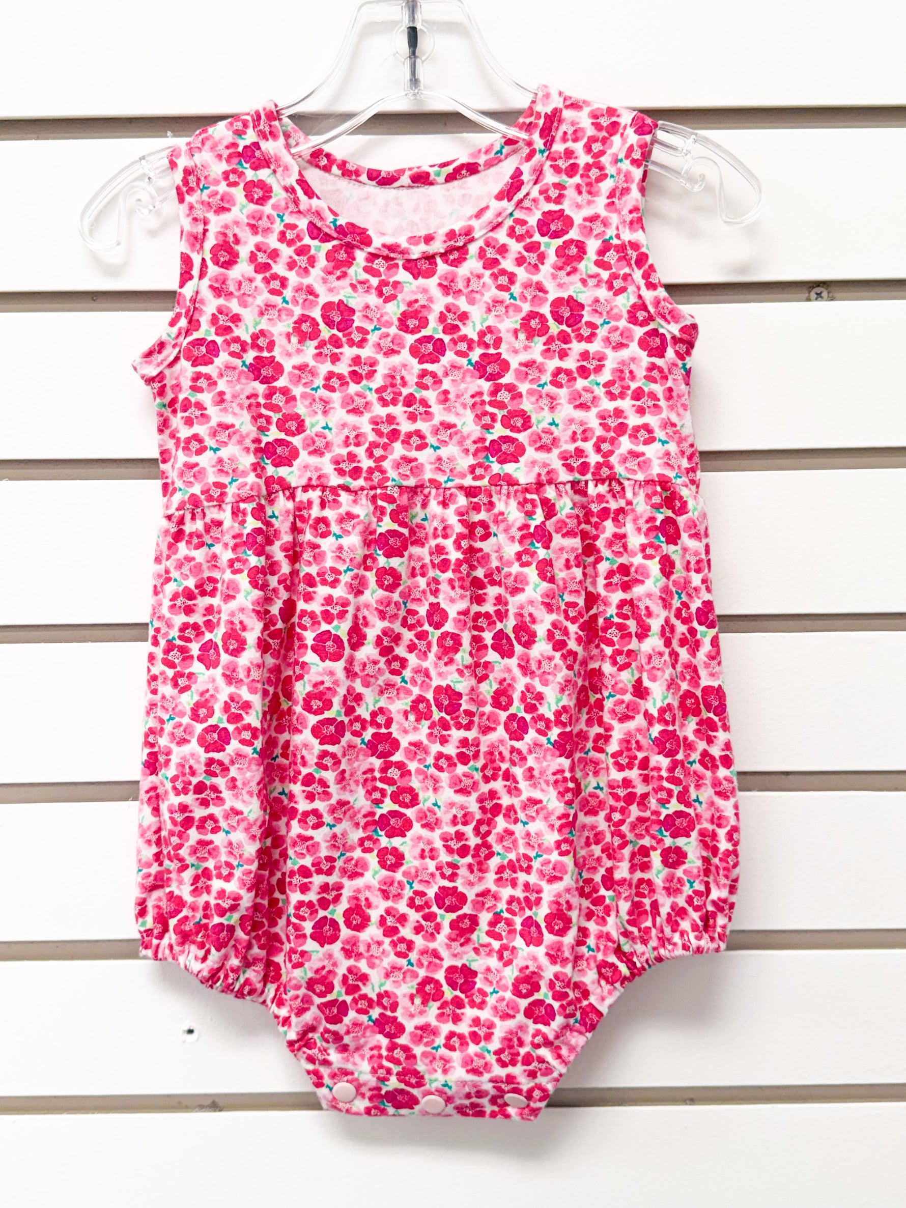 Baby girl pink floral sleeveless bubble romper with snap closure, size 18 months