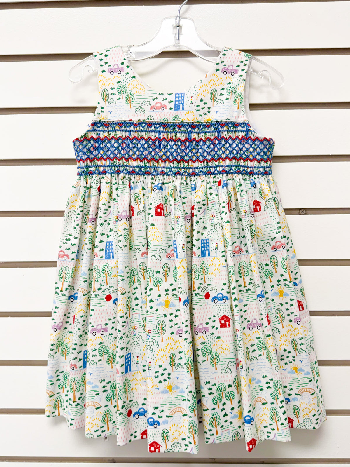 Girl's white sleeveless dress, colorful town print, blue smocked waist, size 3