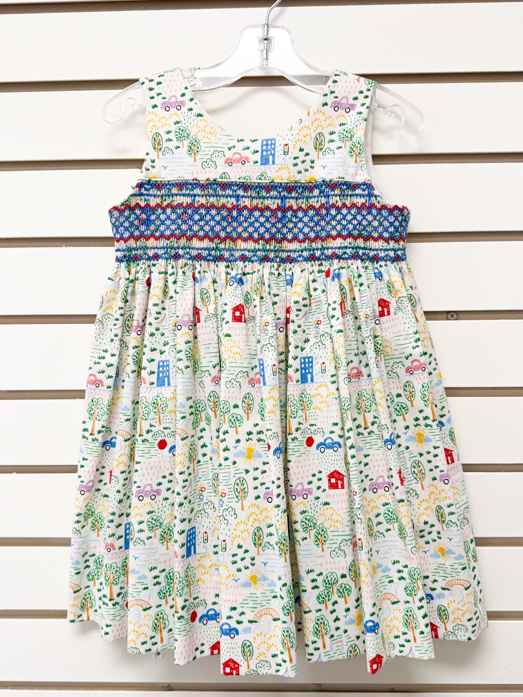 Girl's white sleeveless dress, colorful town print, blue smocked waist, size 3