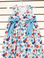 Girl's white floral sundress with red and blue flowers and blue gingham bow sash