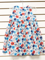 Girl's white sleeveless dress with red, navy, and light blue daisy floral print