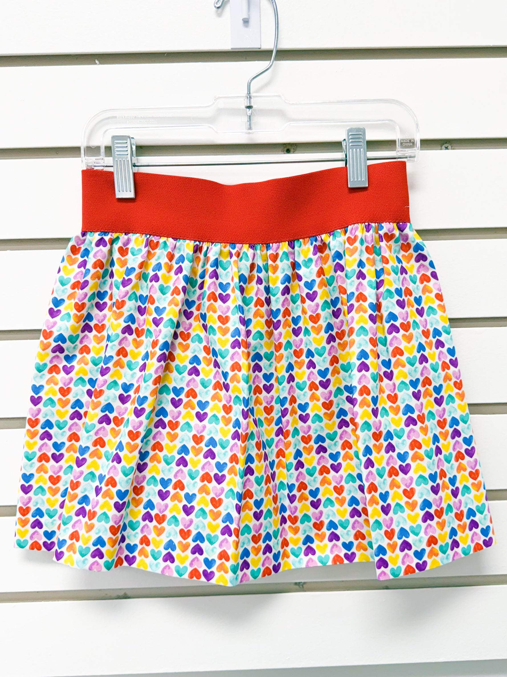 Girls size 4 elastic waist skirt with colorful rainbow hearts print and red waistband
