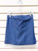 Blue textured mini skort with waistband, displayed on a clear clip hanger