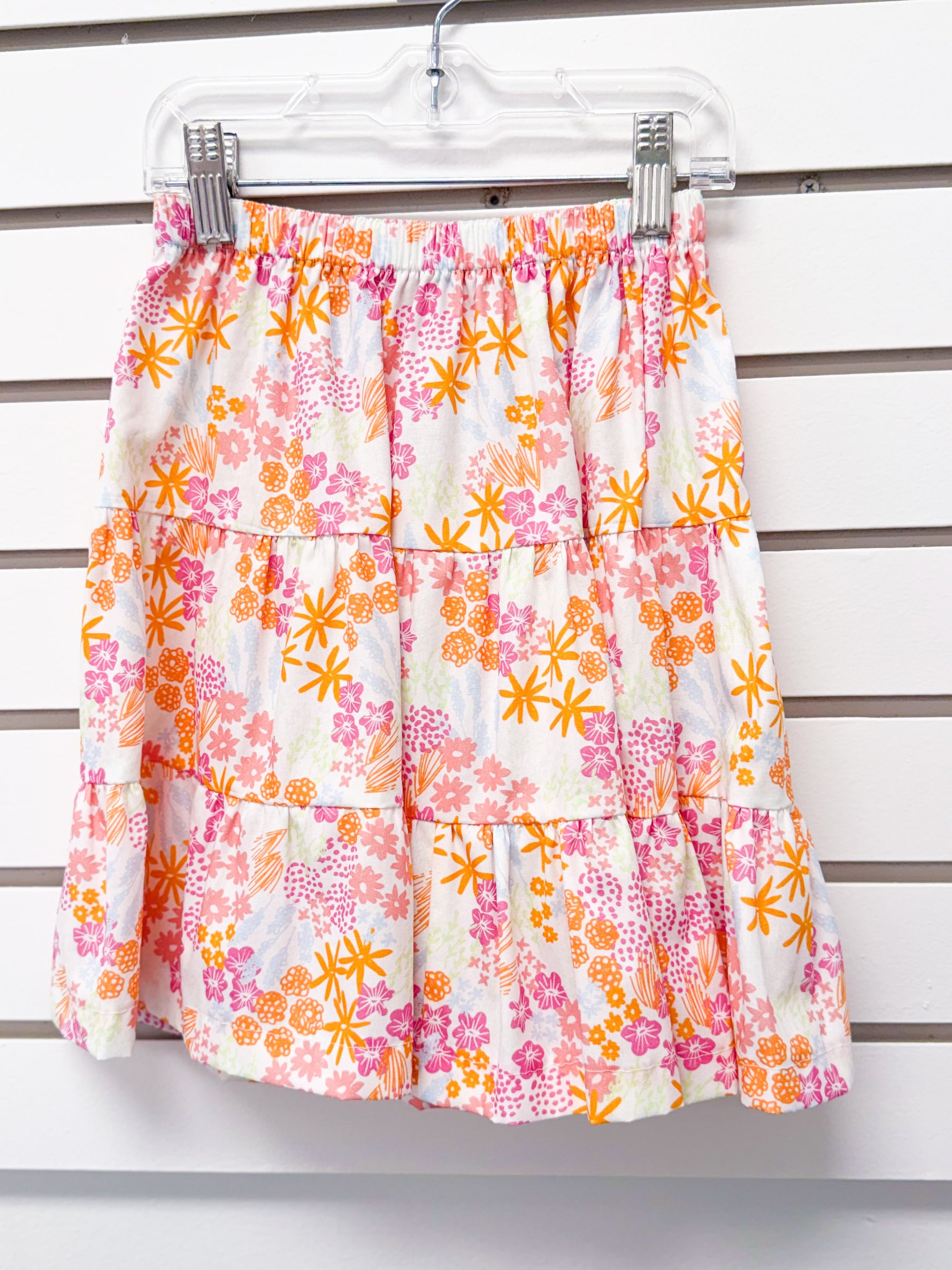 Girls tiered skirt with elastic waist, white with pink and orange floral print, size 4