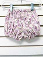 Baby bloomer shorts in white floral print with purple and pink flowers, elastic waist and legs