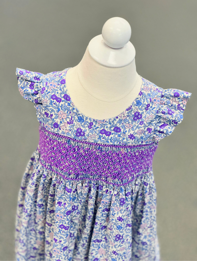 Purple floral smocked girls dress kit with flutter sleeves on white mannequin