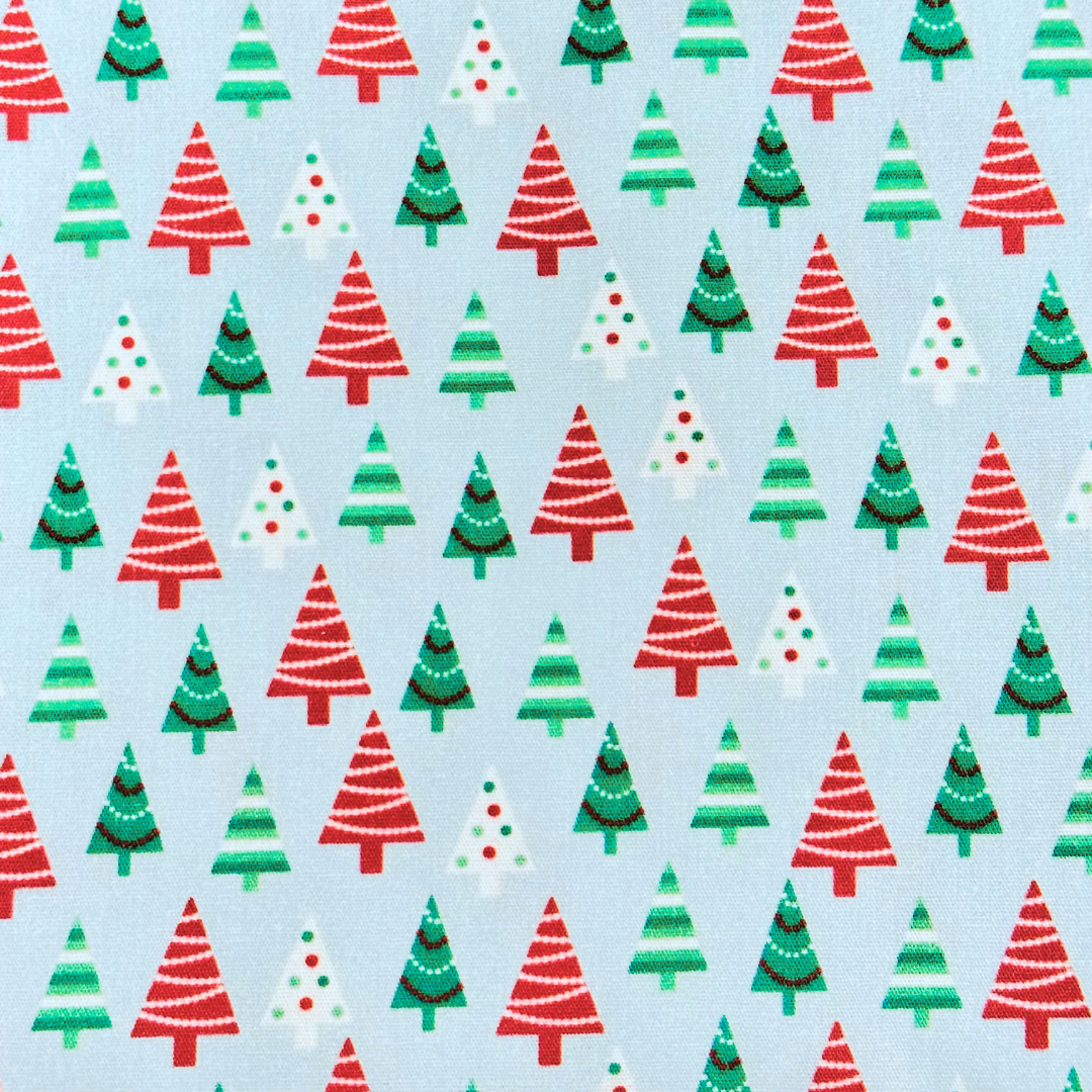 Light blue fabric with red, green, and white Christmas tree pattern repeat