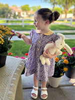 Toddler girl wearing purple floral Georgia dress with yellow gingham Peter Pan collar