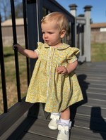 Toddler girl wearing yellow floral Georgia dress with sailor collar and white trim