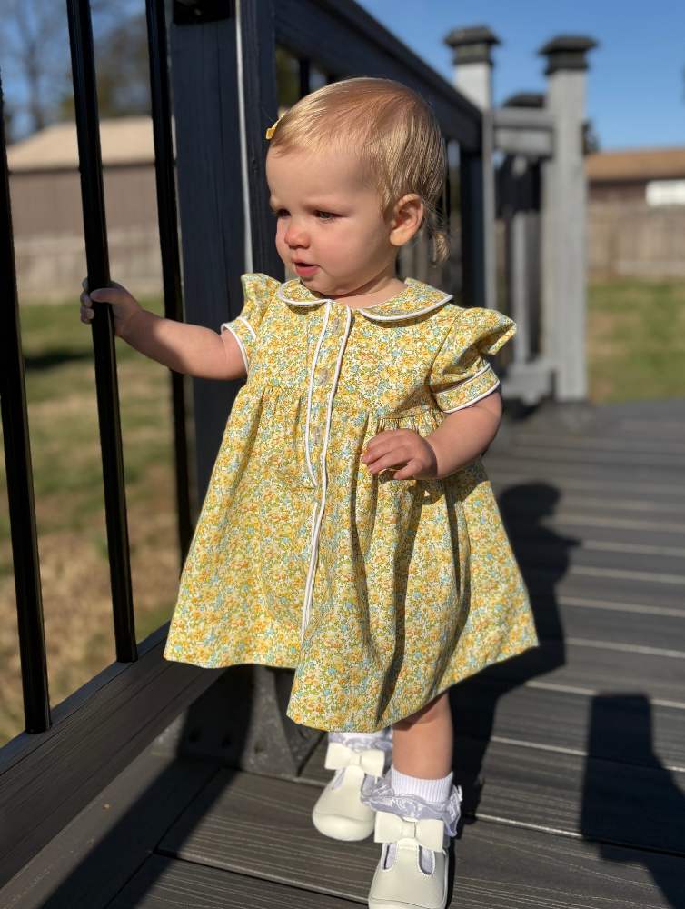 Toddler girl wearing yellow floral Georgia dress with sailor collar and white trim