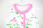 White fabric with pink flamingo print, shown as a finished child's sleeveless top