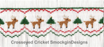 Smocked white fabric with reindeer, Christmas trees, red and green zigzag stitching pattern.