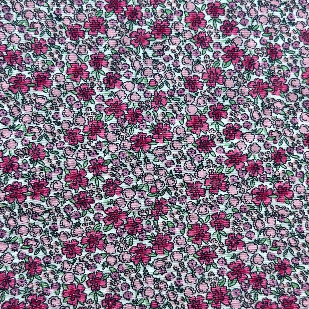 Raspberry Punch Floral fabric with dense pink and magenta flowers on white background