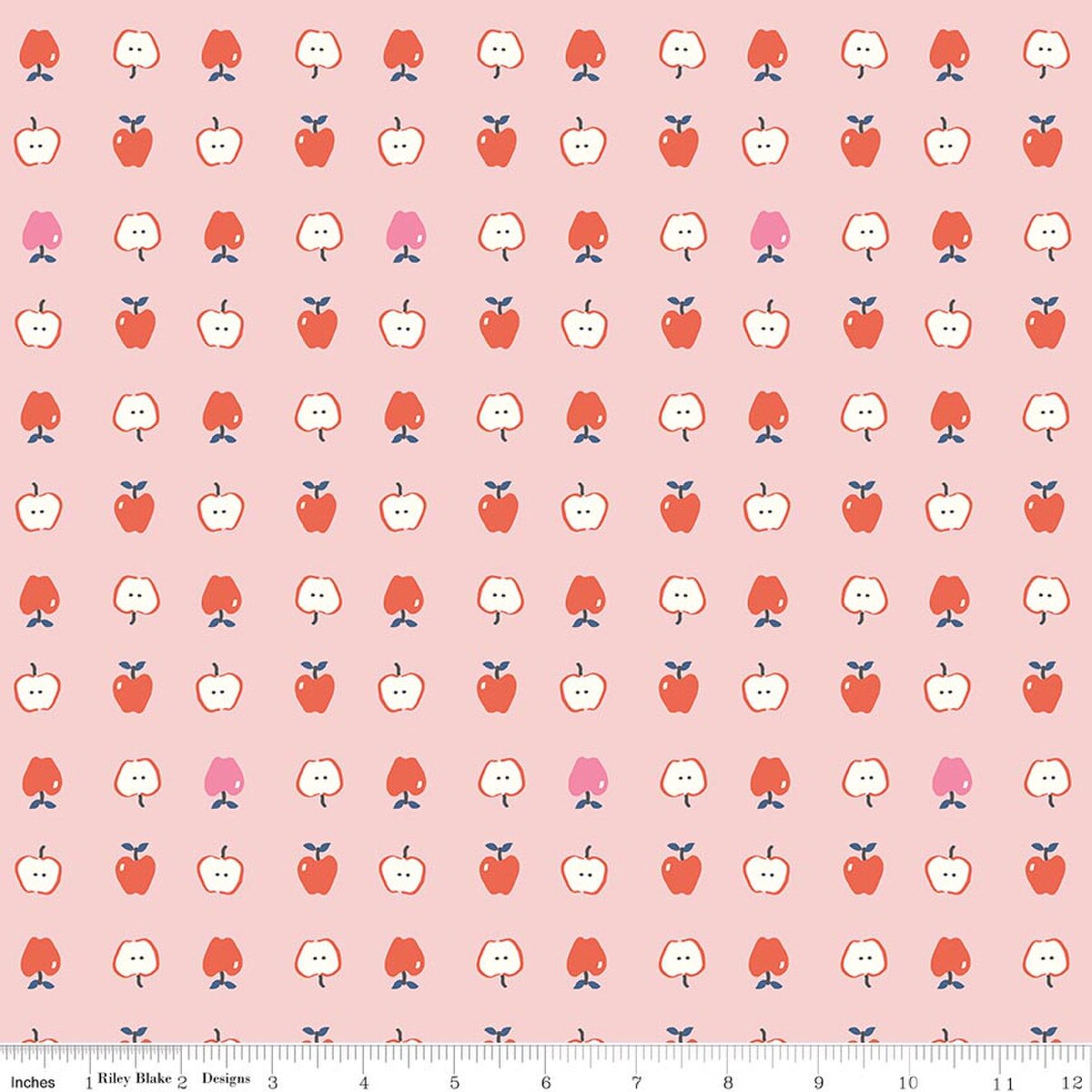 Pink cotton fabric with red and white apple print, whole and halved apples pattern