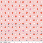 Pink cotton fabric with red and white apple print, whole and halved apples pattern