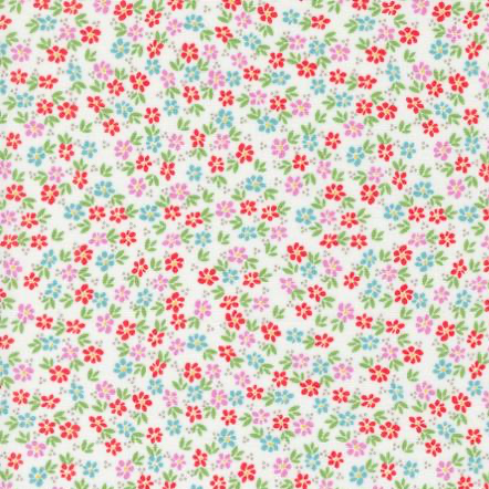 White cotton fabric with scattered small red pink and blue floral ditsy print