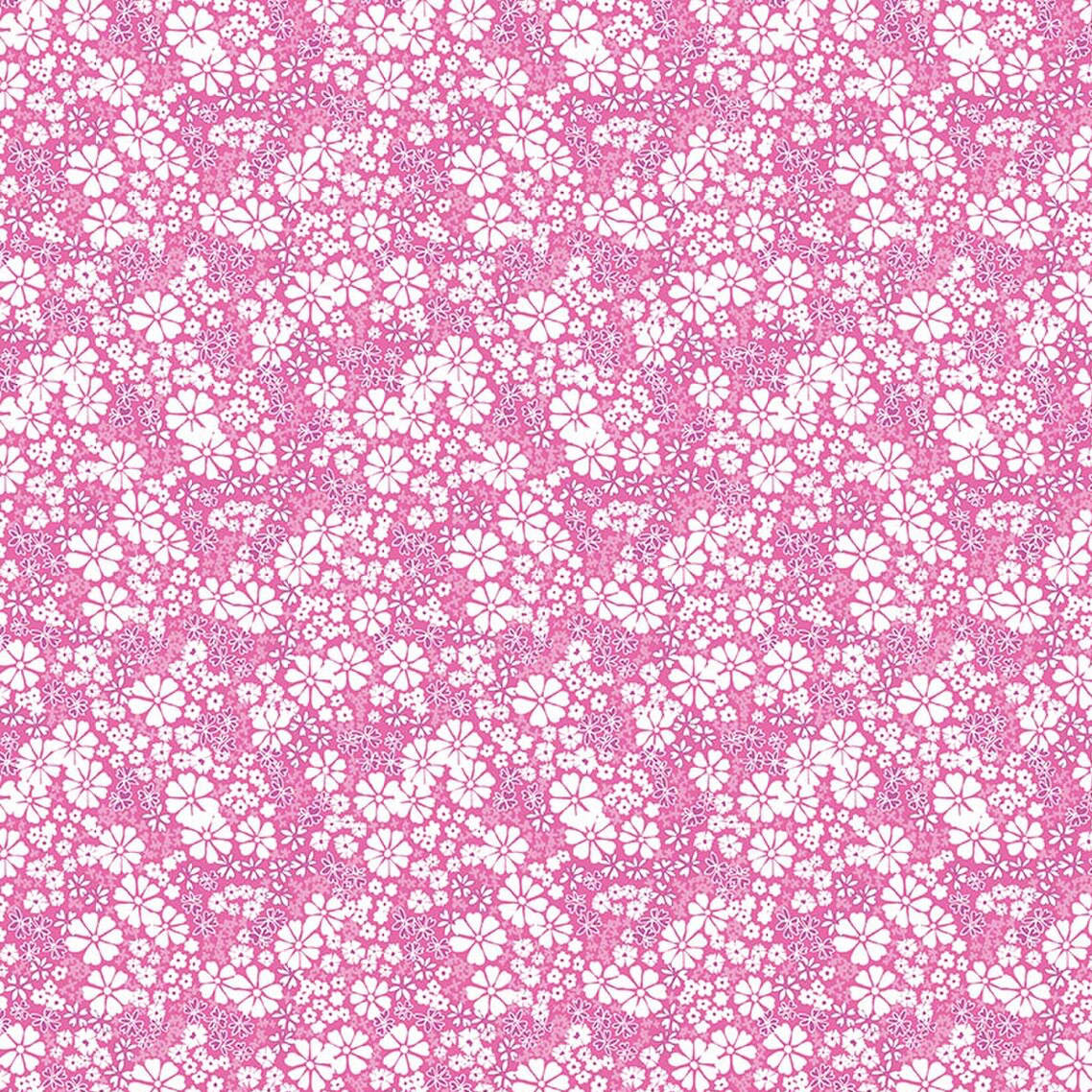 Pink quilting fabric with dense white floral pattern in varying sizes