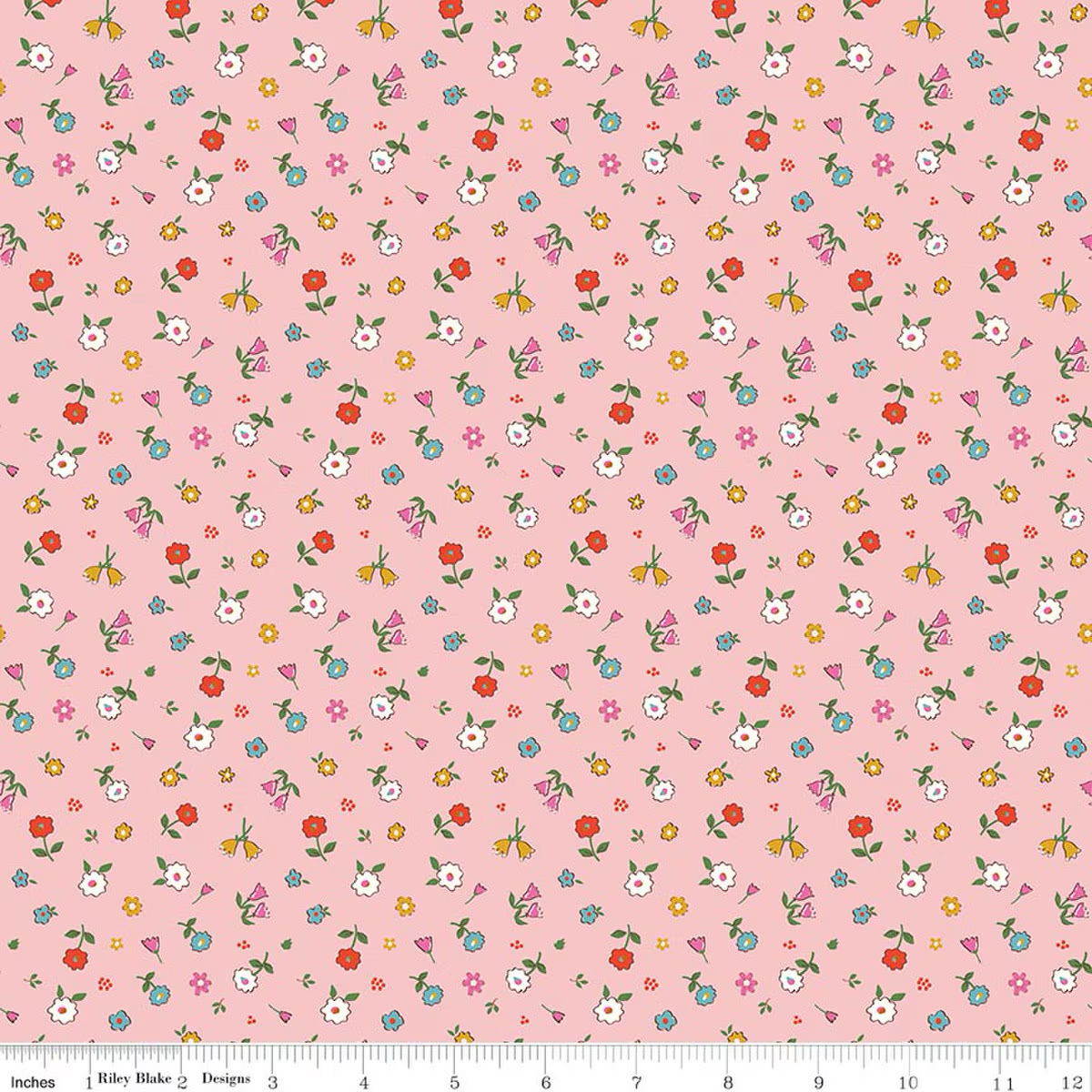 Pink cotton fabric with scattered multicolor ditsy floral print by Riley Blake