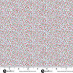 Light blue cotton fabric with tiny pink floral ditsy print, shown with ruler
