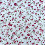 White cotton fabric with crimson and pink rose floral vine print by Fabric Finders