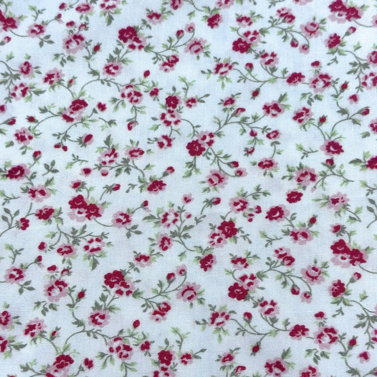 White cotton fabric with crimson and pink rose floral vine print by Fabric Finders