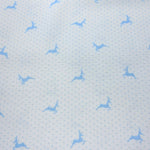 Light blue cotton fabric with small polka dots and scattered leaping reindeer silhouettes