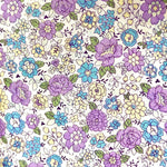Yuwa lawn fabric with purple, blue, and yellow floral print on white background